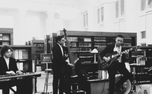 Students Cosimo Fabrizio and Shaan Pandiri playing jazz instruments in the Langdell Library reading room